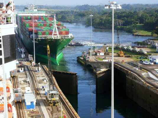 containership transferring cargo through an expanded panama canal