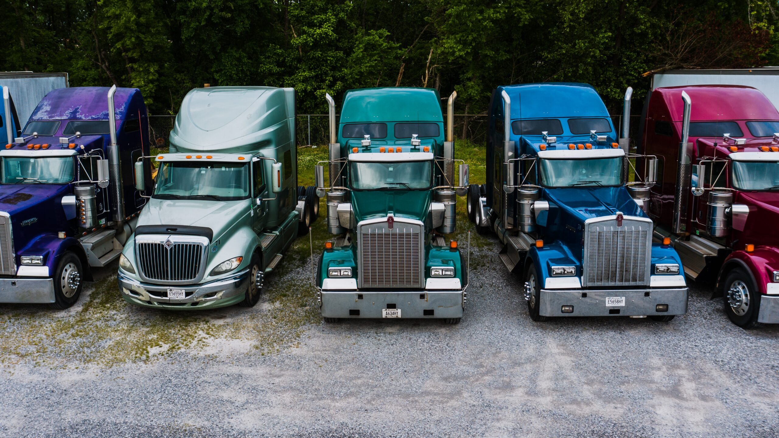 different colored trucks used to transport cargo parked