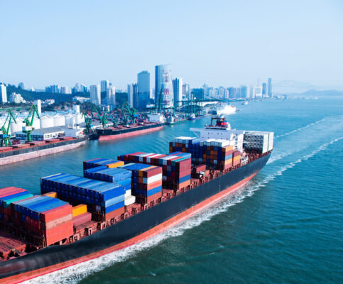 large containership brining cargo into a port as part of supply chains