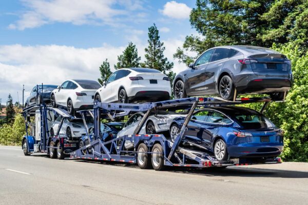 imported cars being transported to by truck