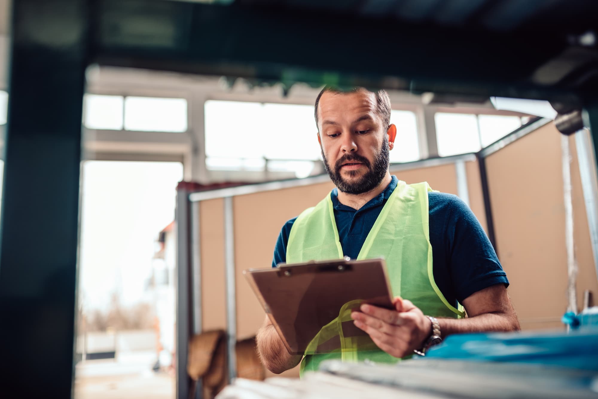 a warehouse worker checking freight that will be packed and picked