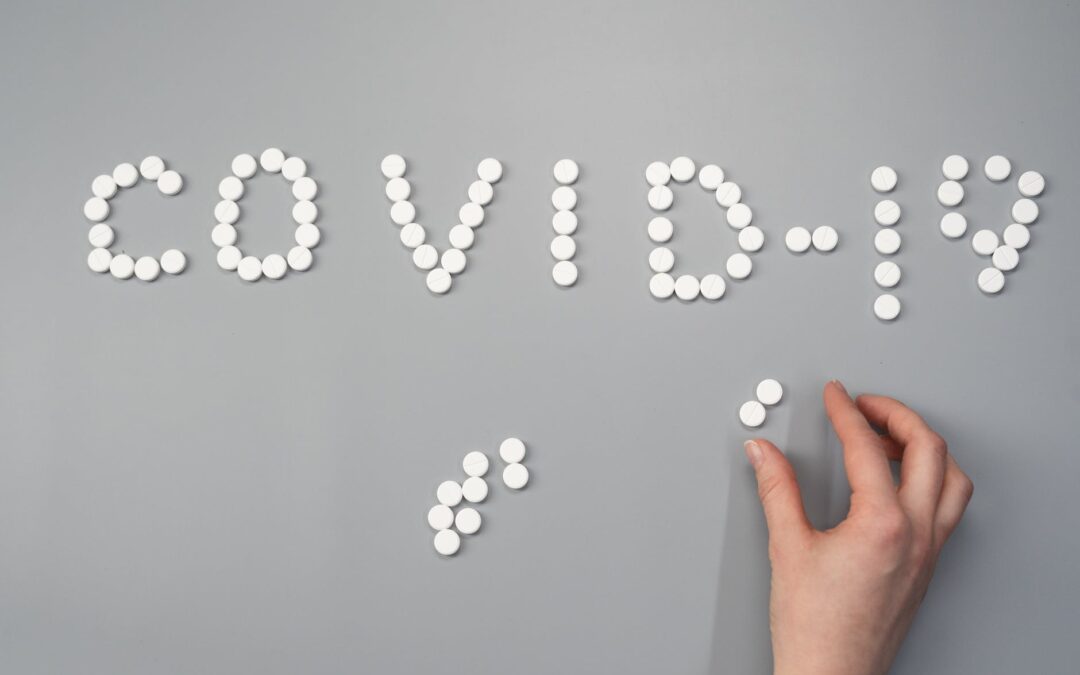Dozens of tablet medicine grouped together to spell Covid-19.