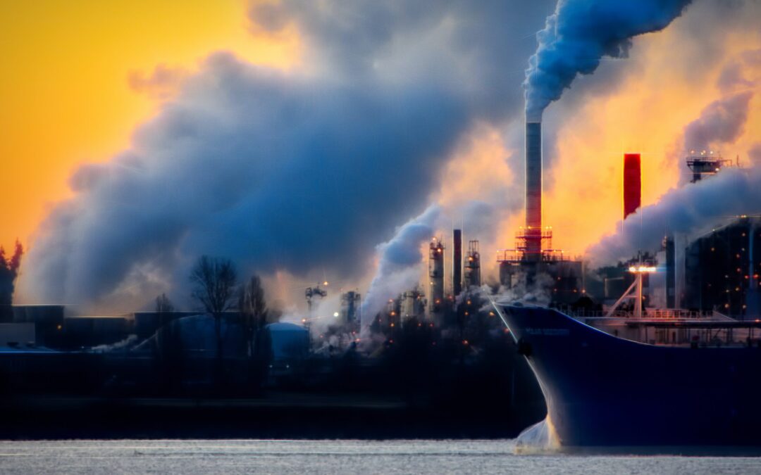 Containership and factory emitting smoke into the air.